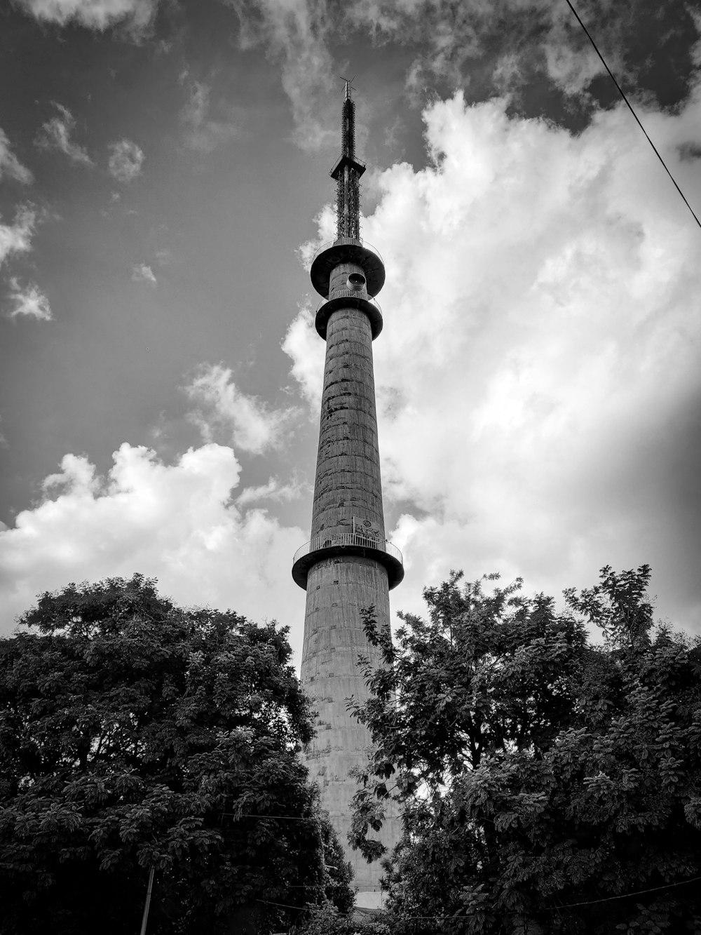 a tall tower with trees around it