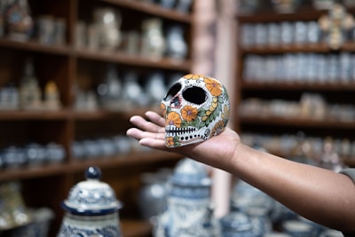 a hand holding a skull