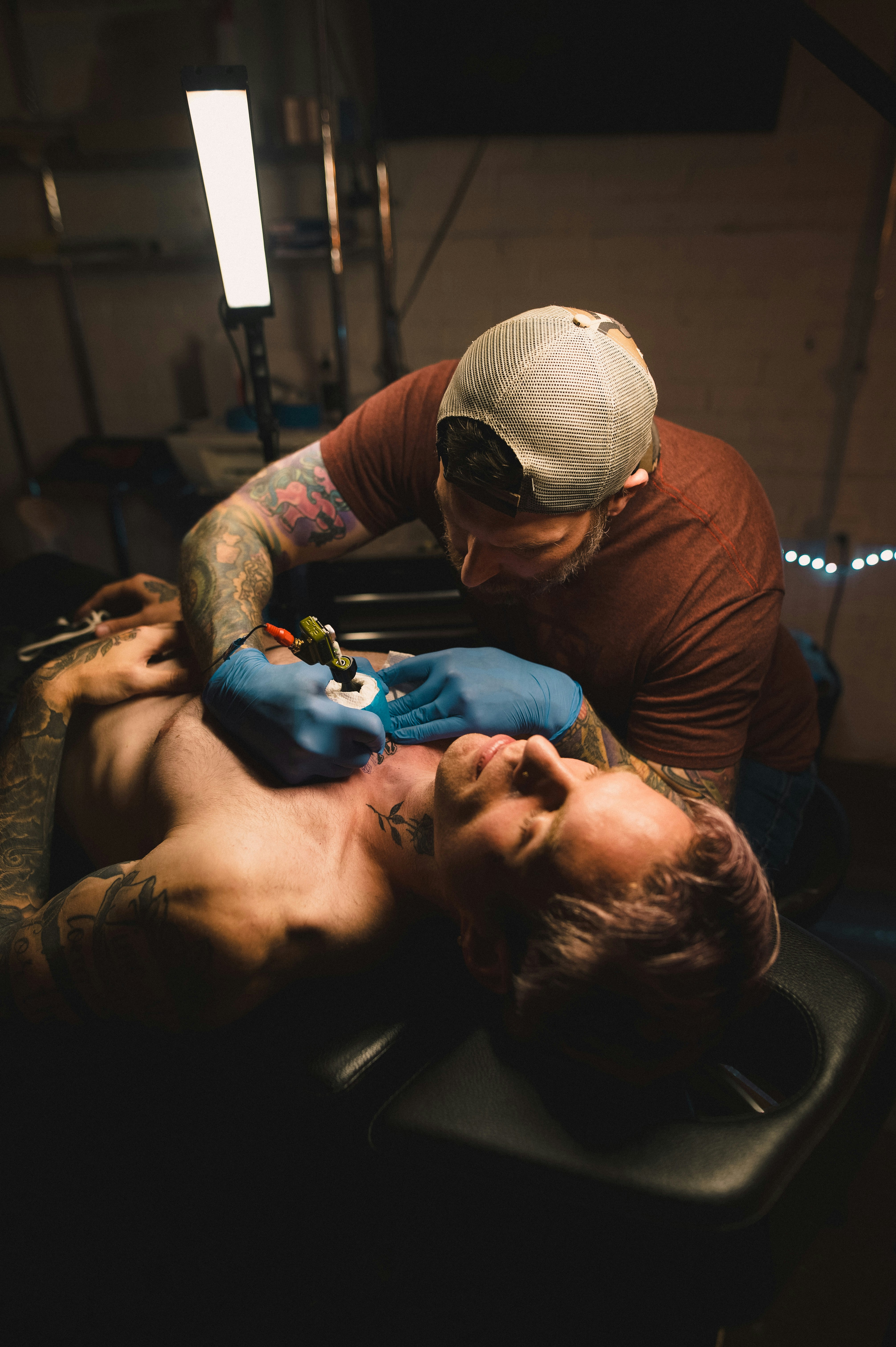 a man attending to a man who is lying down