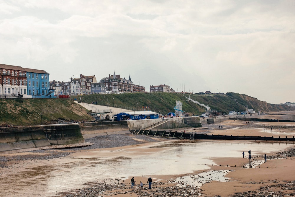 a beach with a bridge and buildings