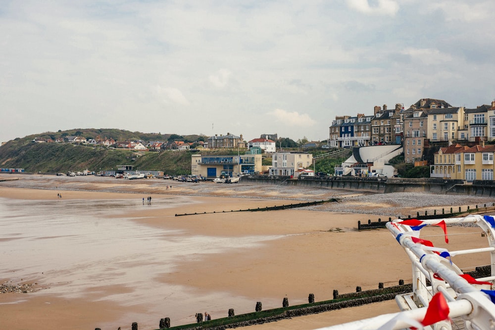 a beach with buildings and trees