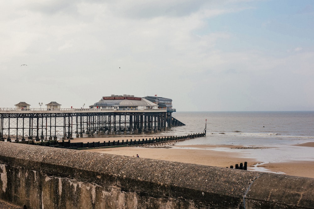 a pier with a building on the shore