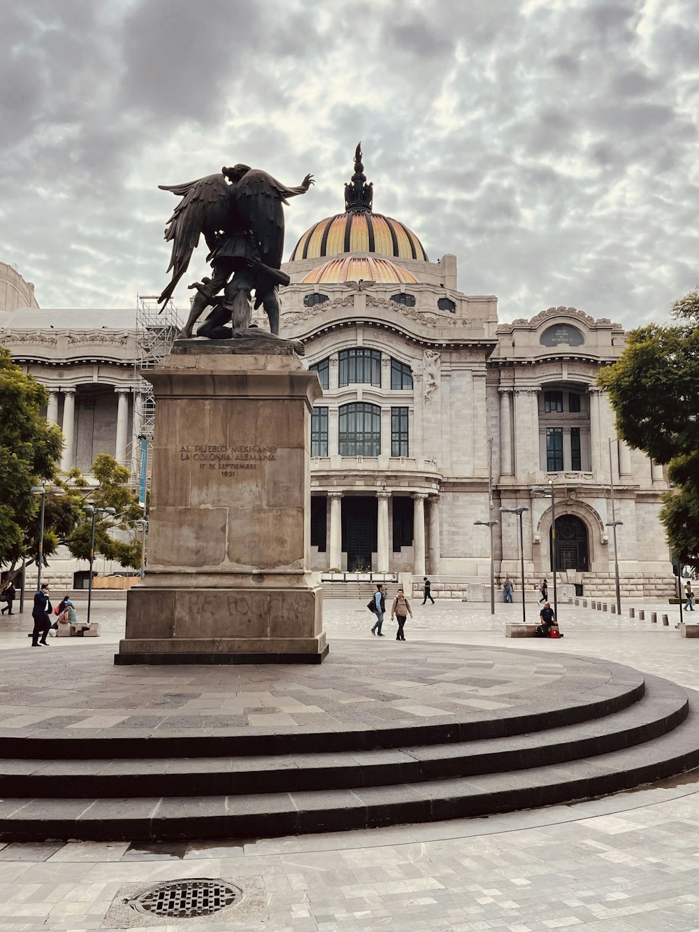 a statue of a person riding a horse in front of a building