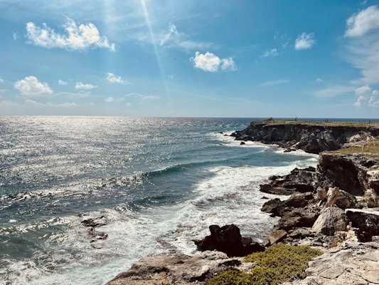 A rocky beach with waves crashing against the shore — Isla Mujeres, Mexico