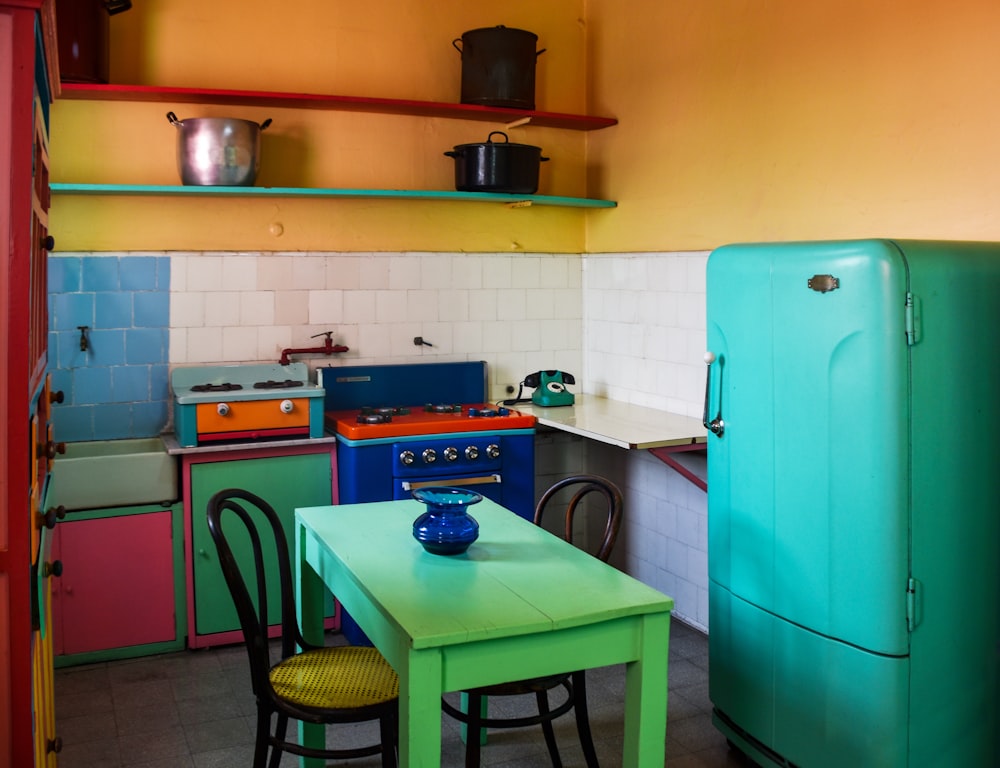 a kitchen with a table and chairs