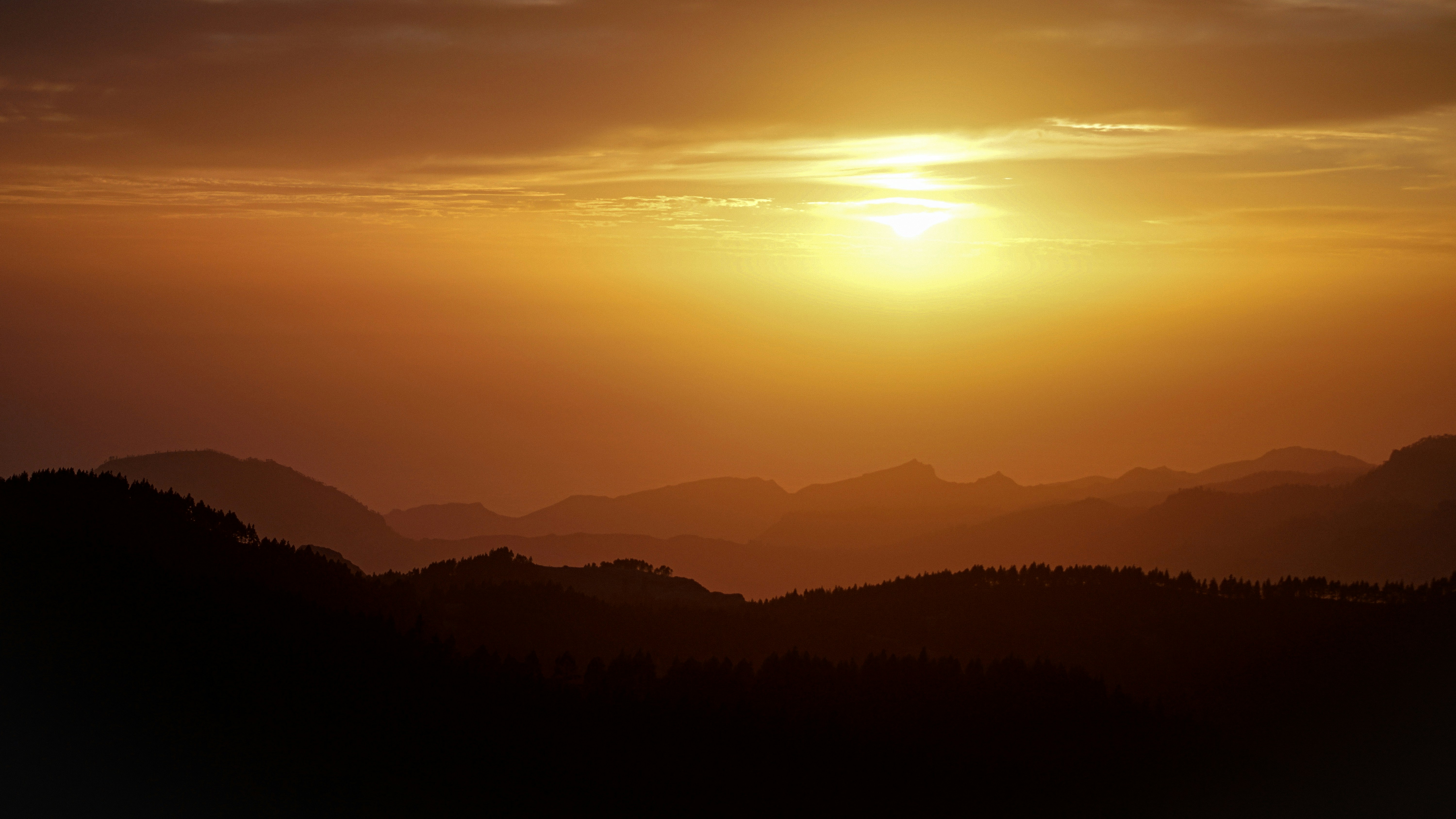 a sunset over a mountain range