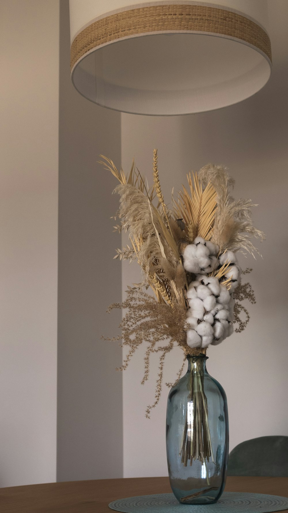 a vase with dried flowers