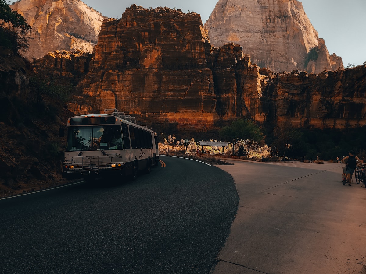 a bus driving through a canyon