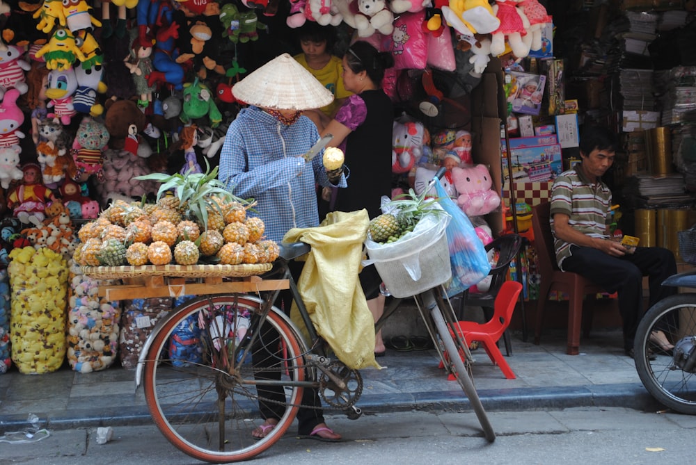 a person selling fruits on a bicycle
