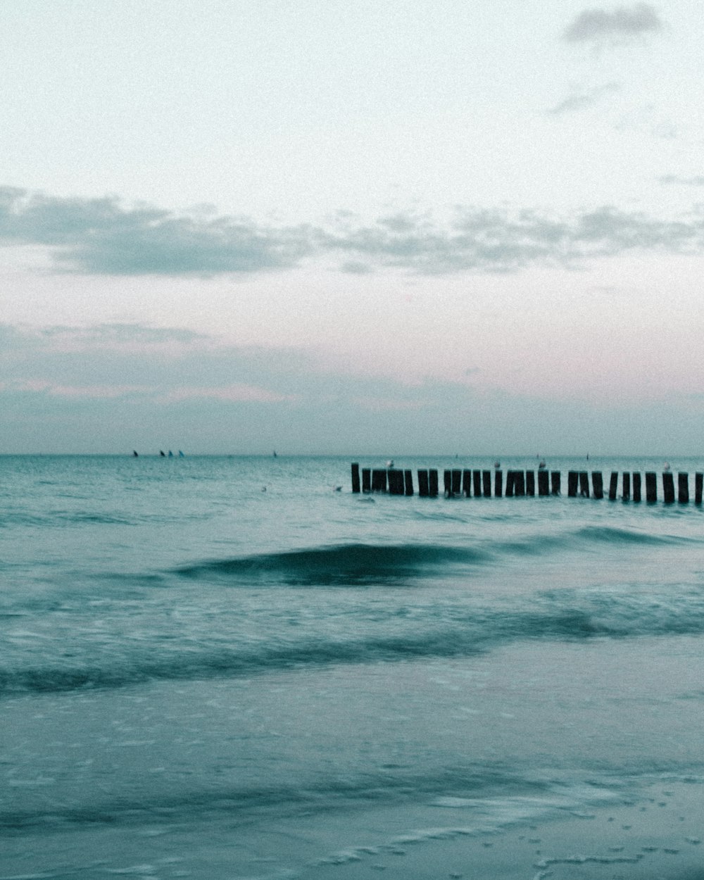 a body of water with a dock in the distance