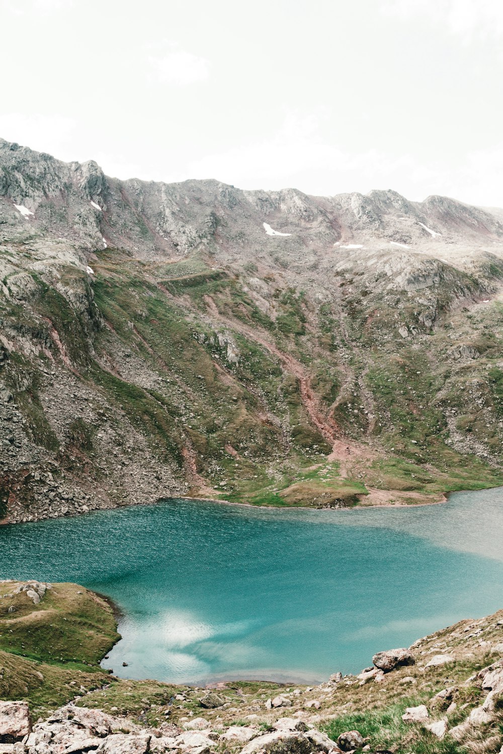 a body of water with a mountain in the background