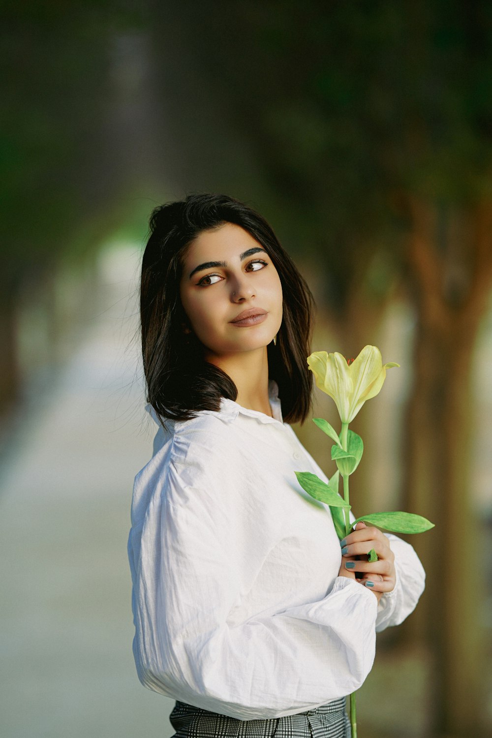 a woman holding a flower