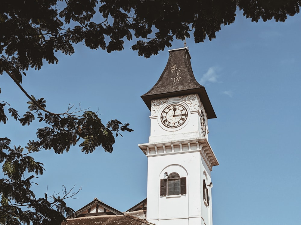 a clock tower with a weather vane