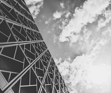 a tall tower with clouds in the background