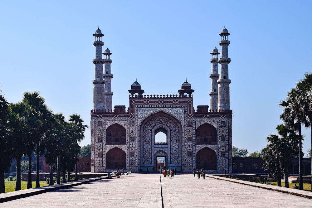 a large building with towers with Tomb of Akbar the Great in the background