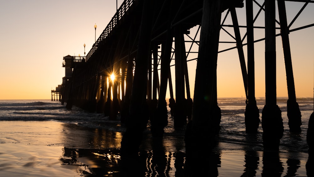 a wooden pier at sunset