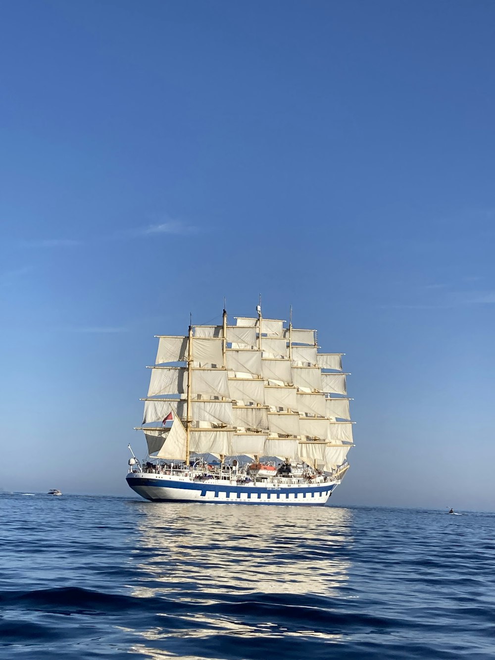 a large white ship with many containers on it