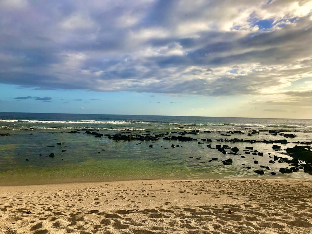 a beach with rocks and water