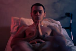 Young man meditating in a serene room, symbolizing focus and calm.