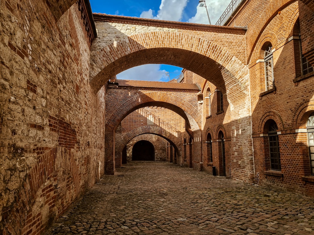 a stone walkway between brick buildings