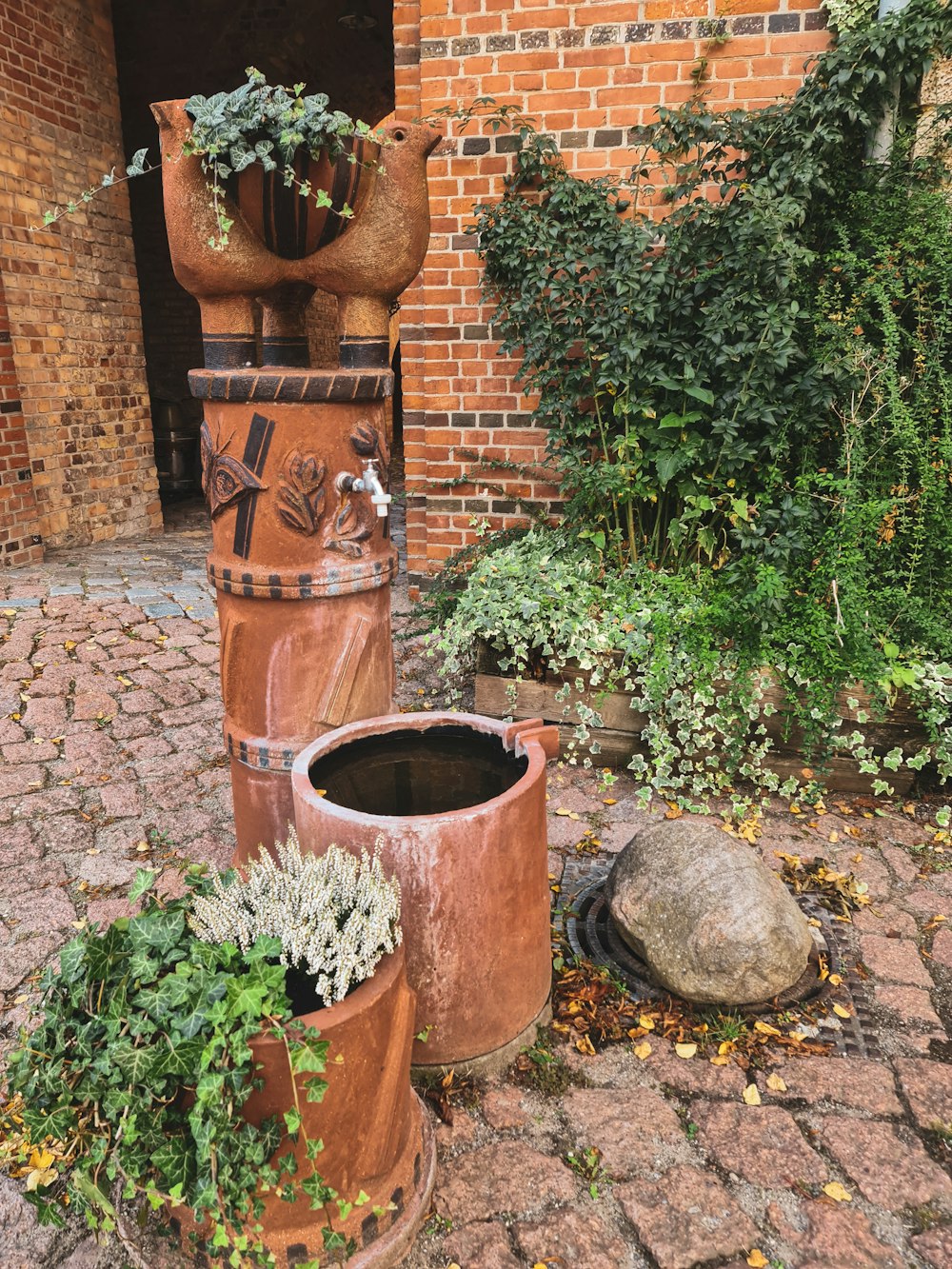 a couple of vases sit on a brick patio