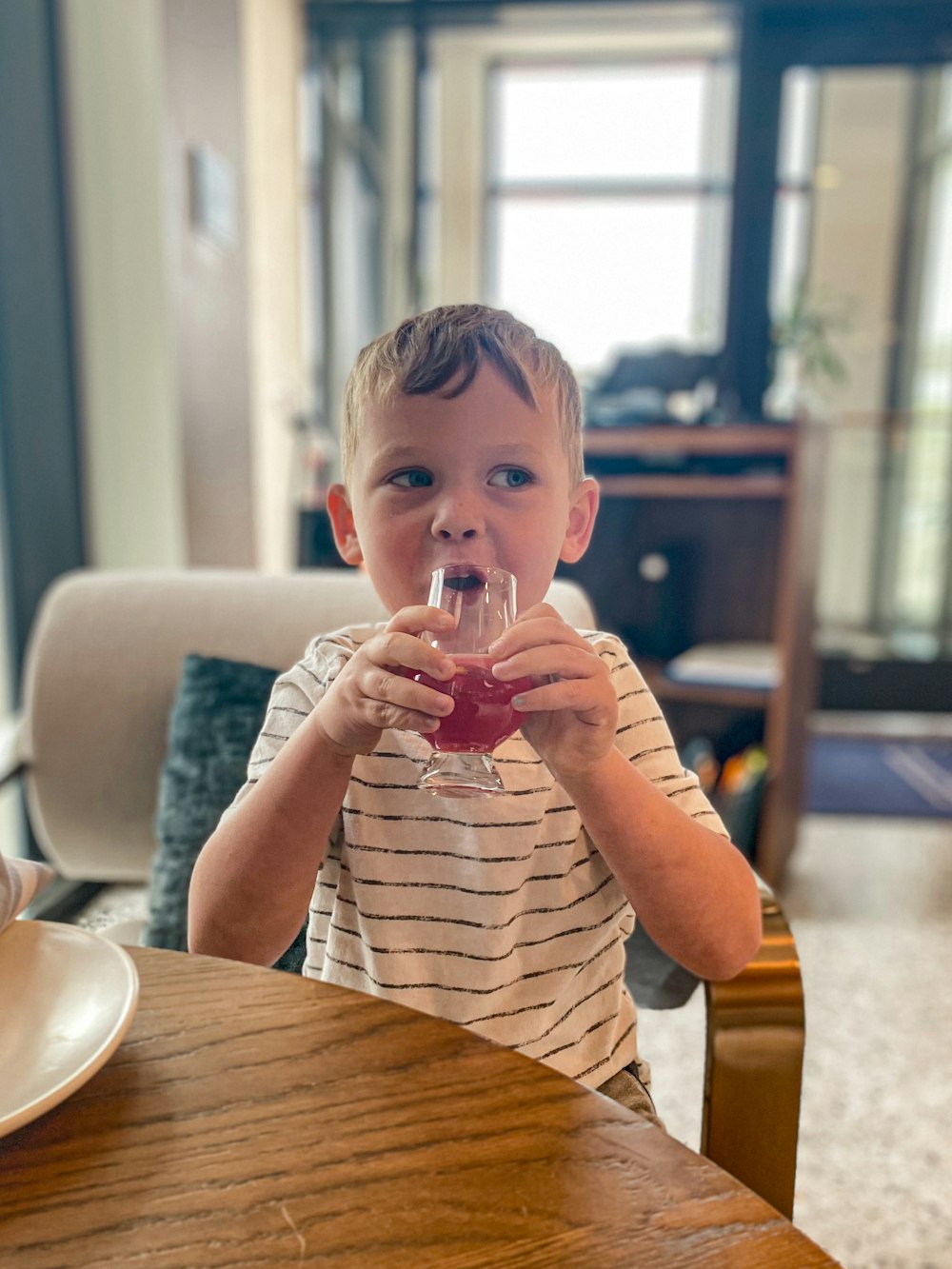 a boy drinking from a glass