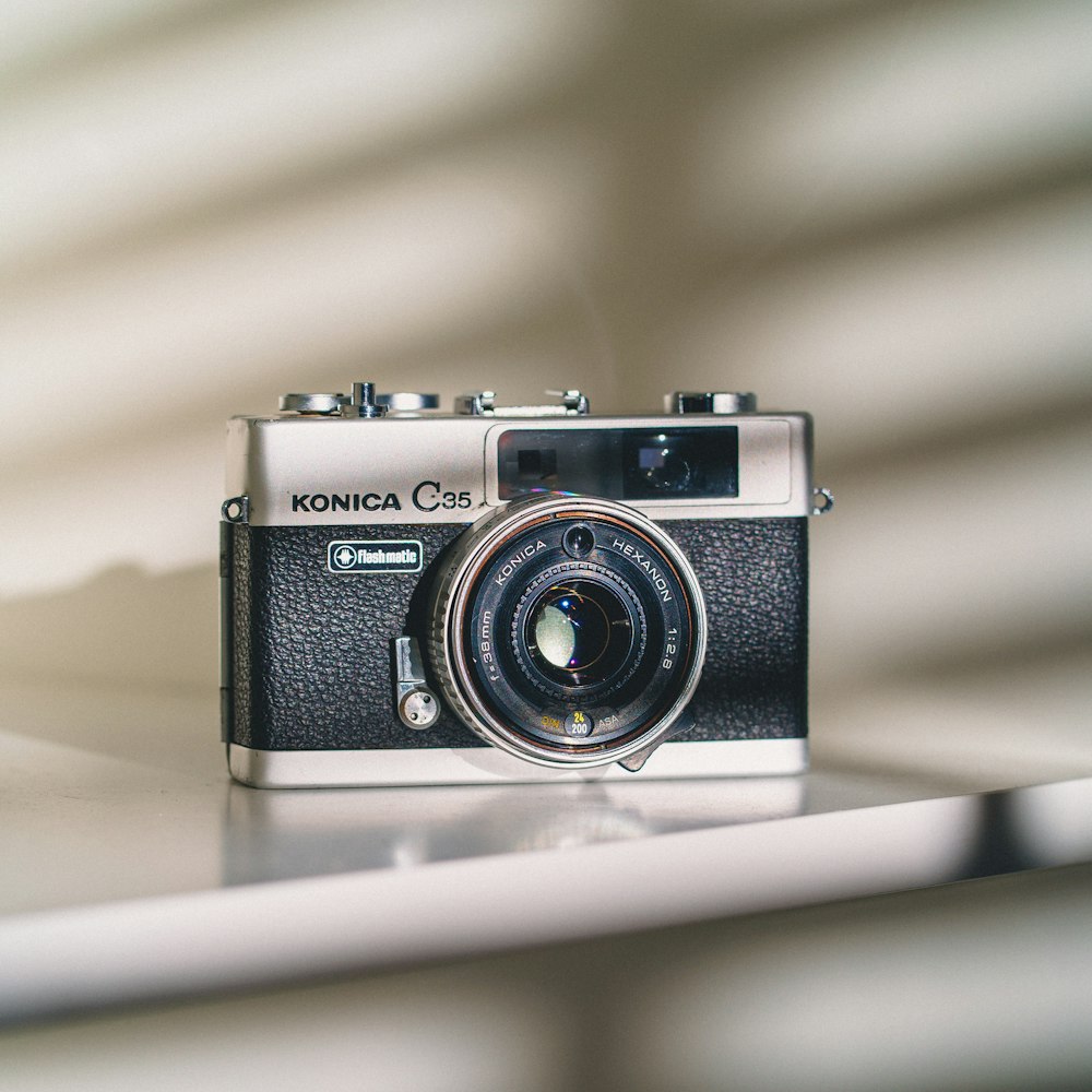 a black camera on a white surface