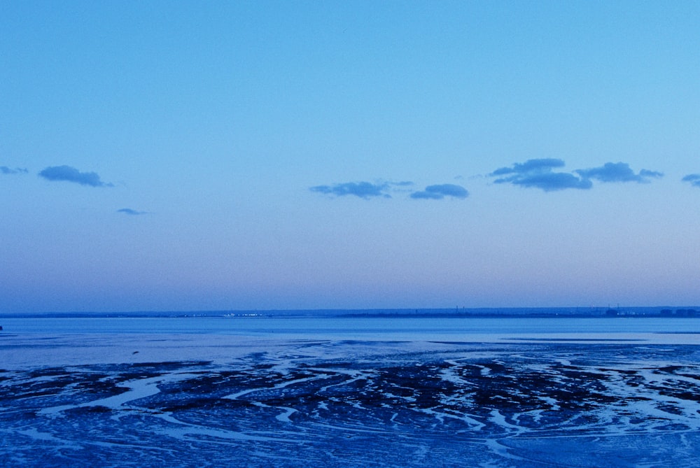 a body of water with ice and snow on it