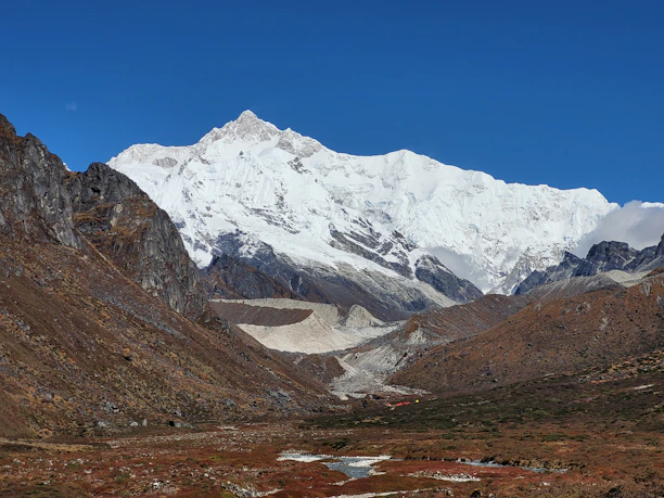 a snowy mountain with a river running through it