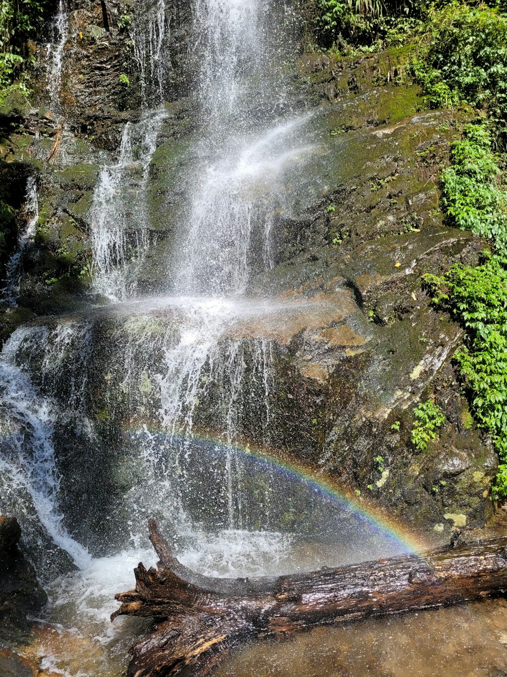 a waterfall with a rainbow