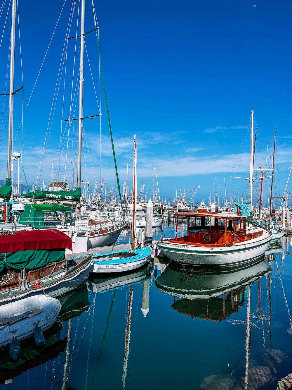 a group of boats sit in a harbor