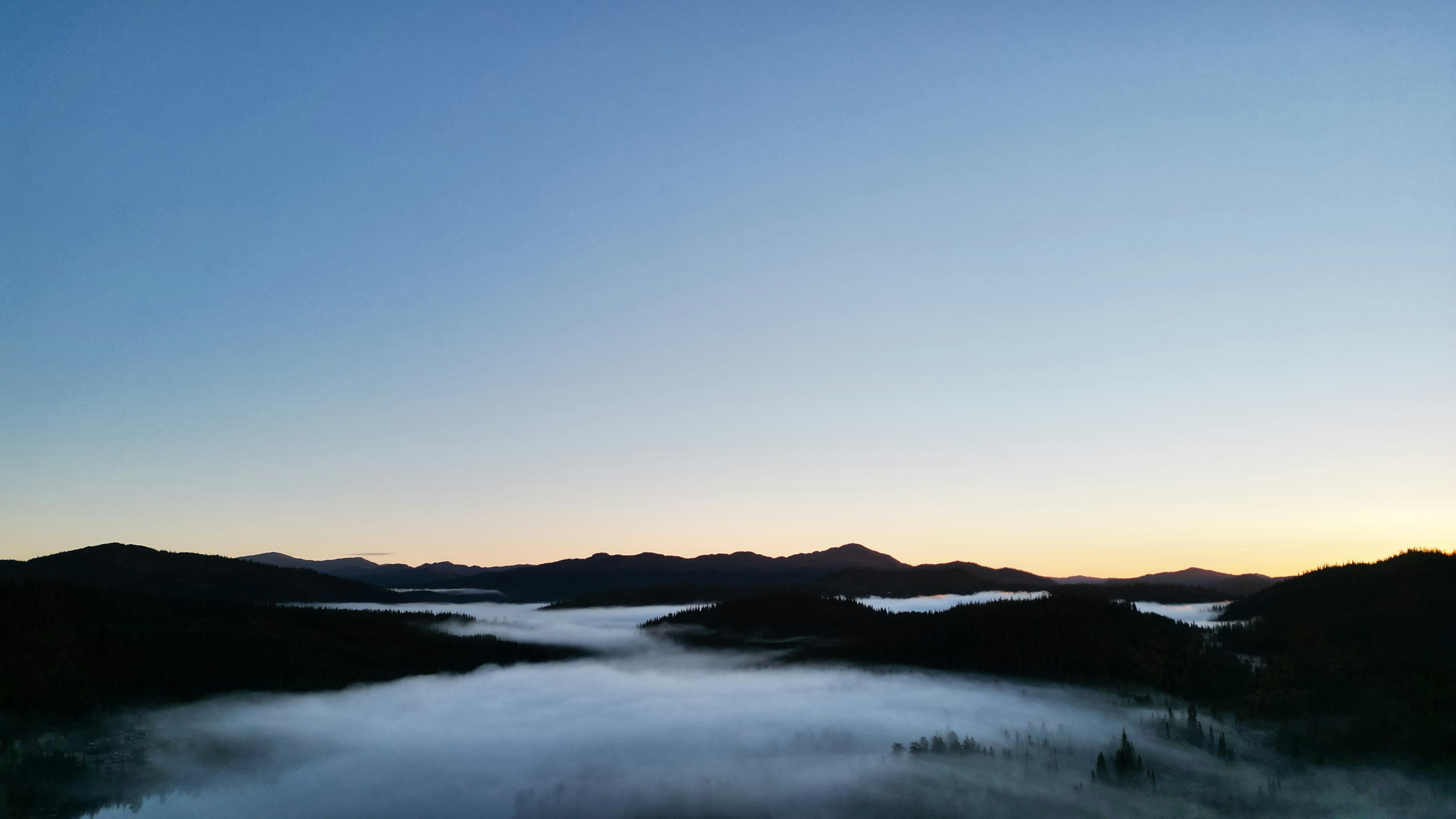 a body of water with mountains in the background