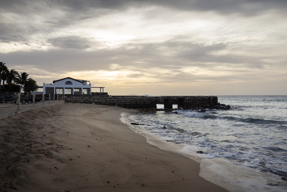 a beach with a pier and buildings