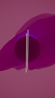A minimalistic abstract composition featuring a large, dark circle at the center, partially overlapped by two thin vertical lines. The background is dominated by gradient shades of purple and pink, with some translucent layers adding depth.