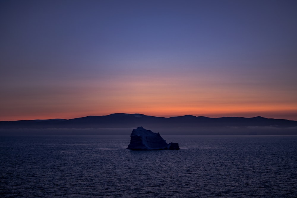 a large body of water with a rock in it