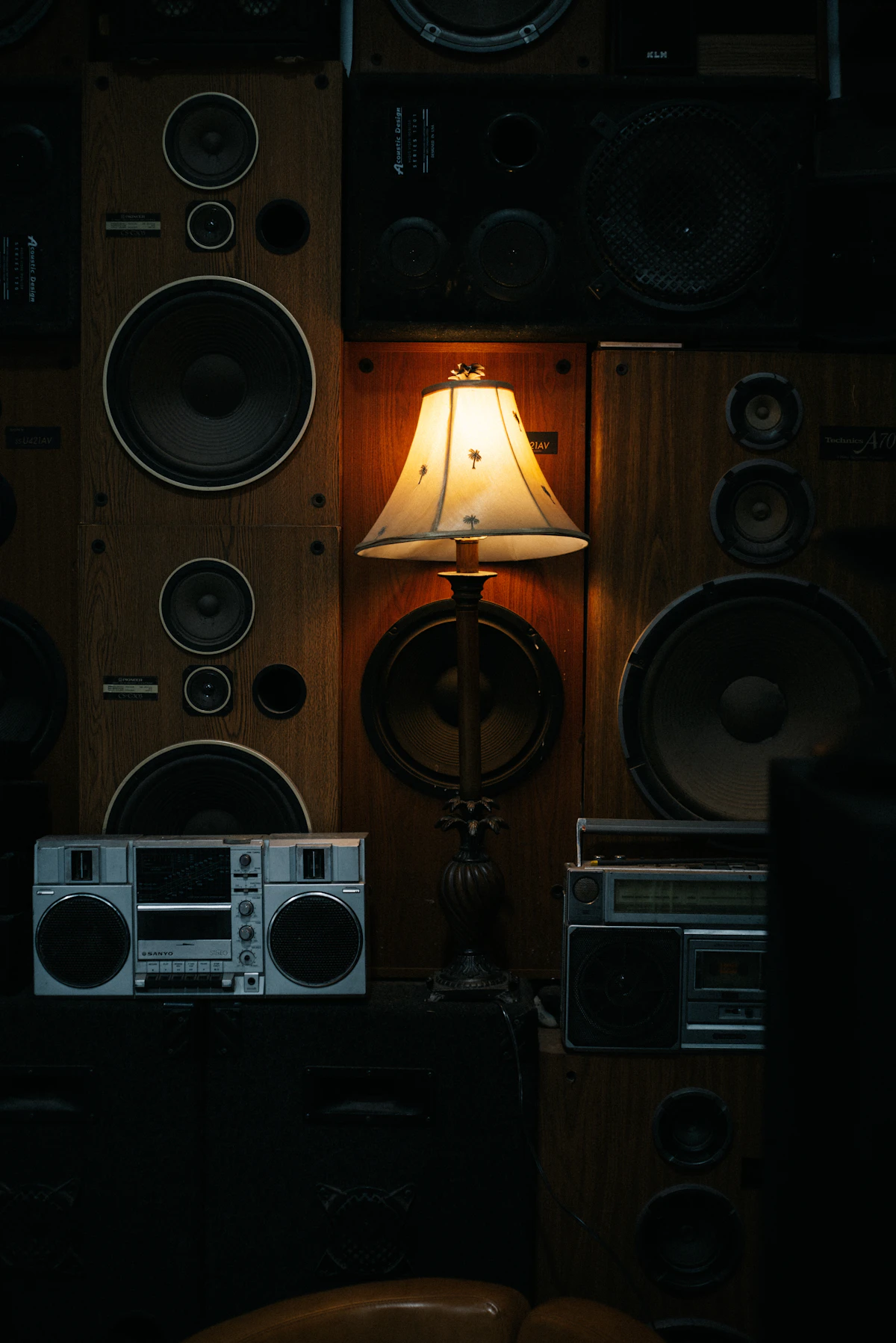 Vintage speakers and audio equipment in warm lamplight