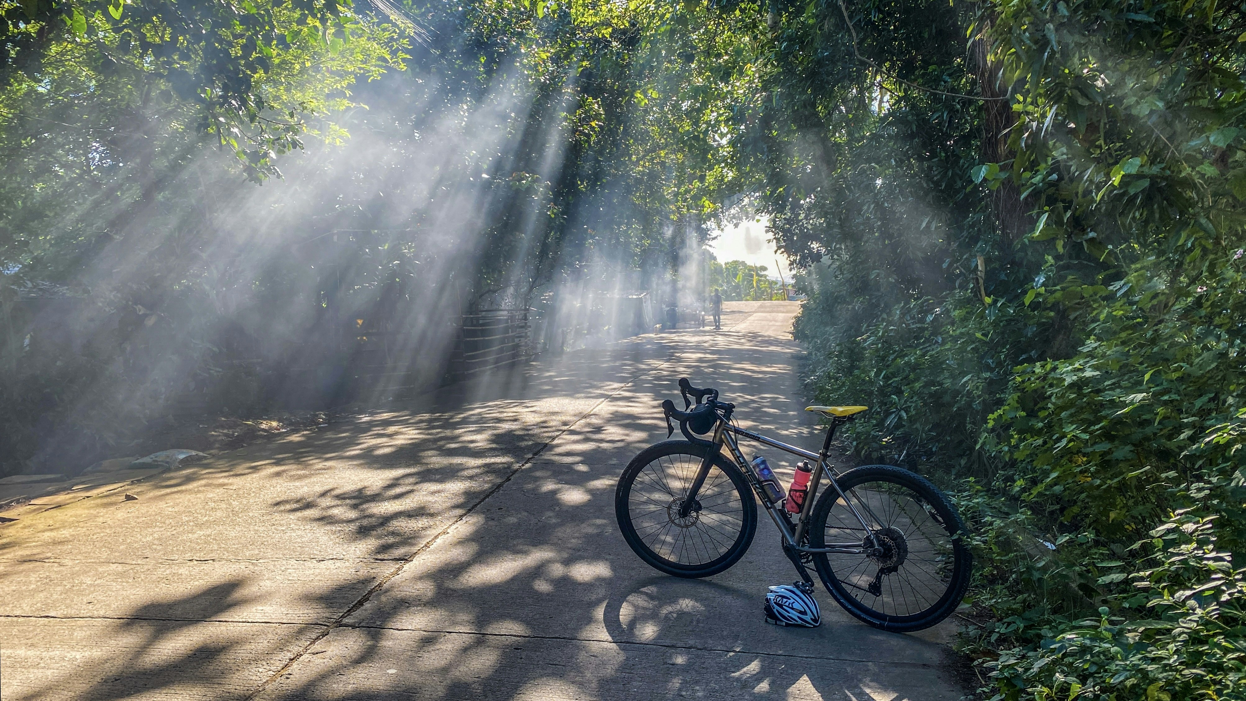 Toyota Tacoma pickup truck driving on a dirt trail through the mountains