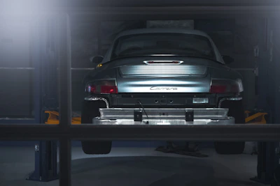 A sleek Audi on the lift undergoing a precision turbocharger upgrade in a bright, organized garage.