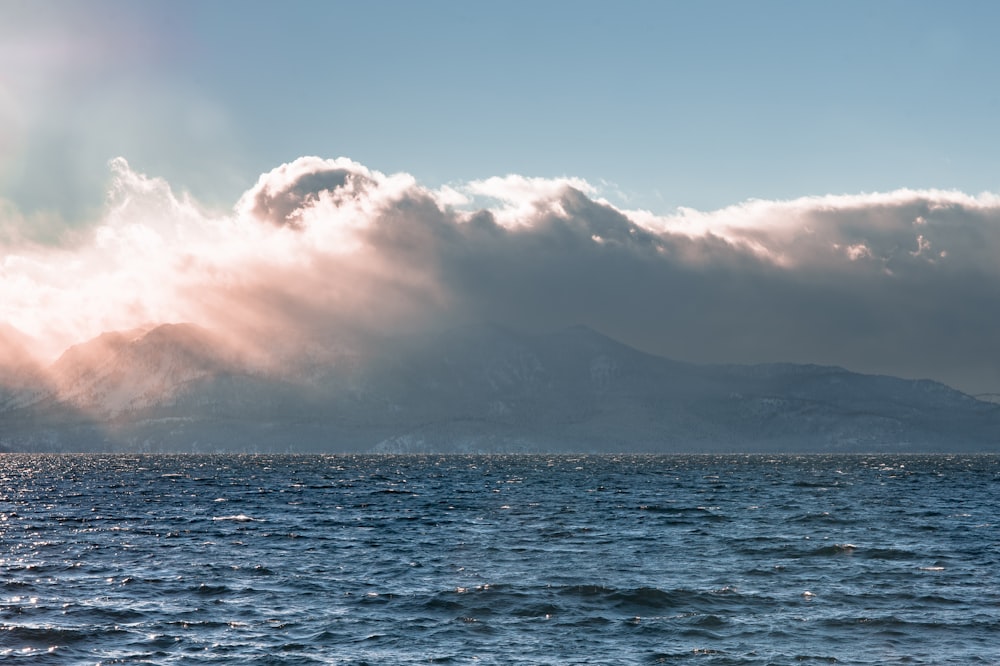 a body of water with a mountain in the background