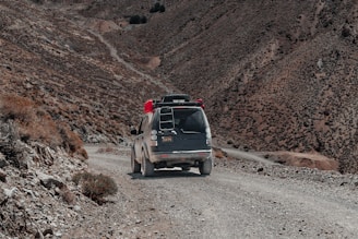 A rugged mountain road with a sturdy taxi cab ready for an adventurous ride.