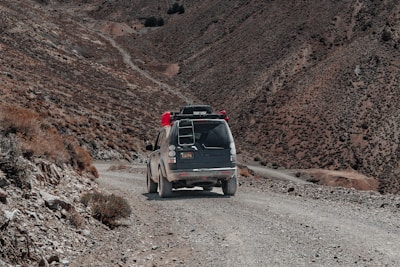 A rugged mountain road with a sturdy taxi cab ready for an adventurous ride.