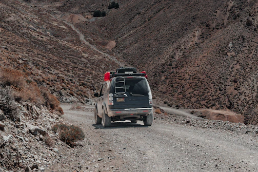 A convoy of trucks loaded with aid supplies navigating rugged terrain in Somaliland.
