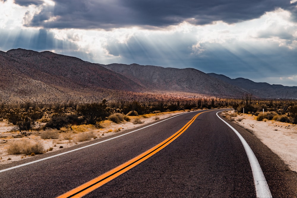 a road with mountains in the background