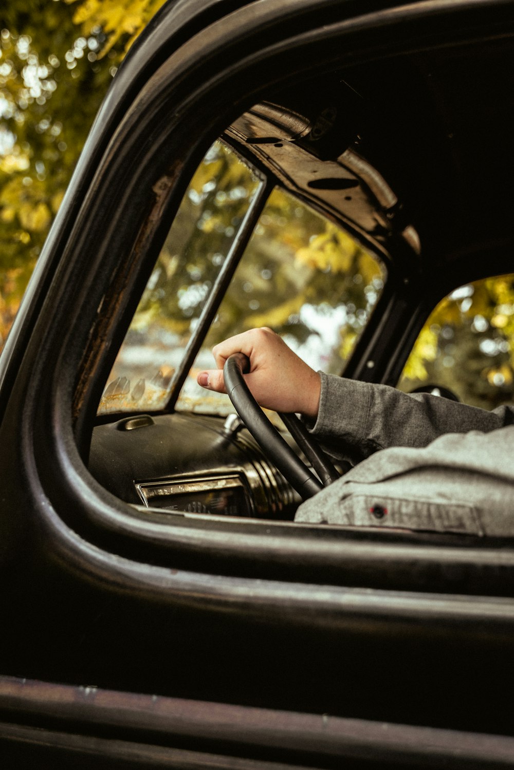 a person holding a gun in a car