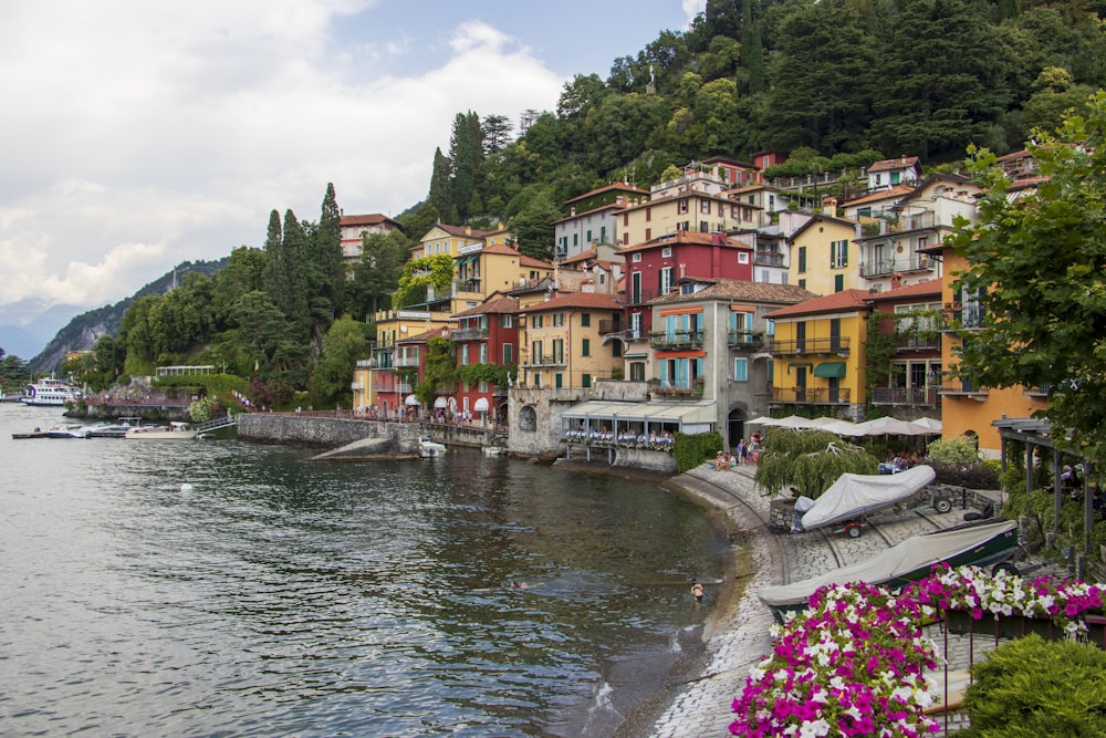 a body of water with buildings along it with Lake Como in the background