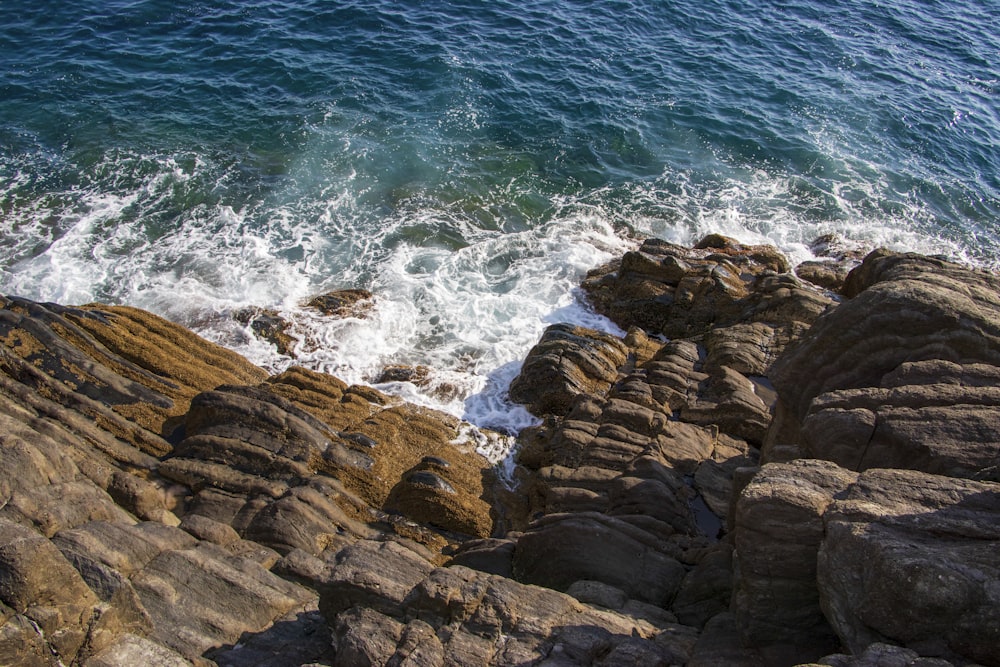 a rocky beach with waves crashing