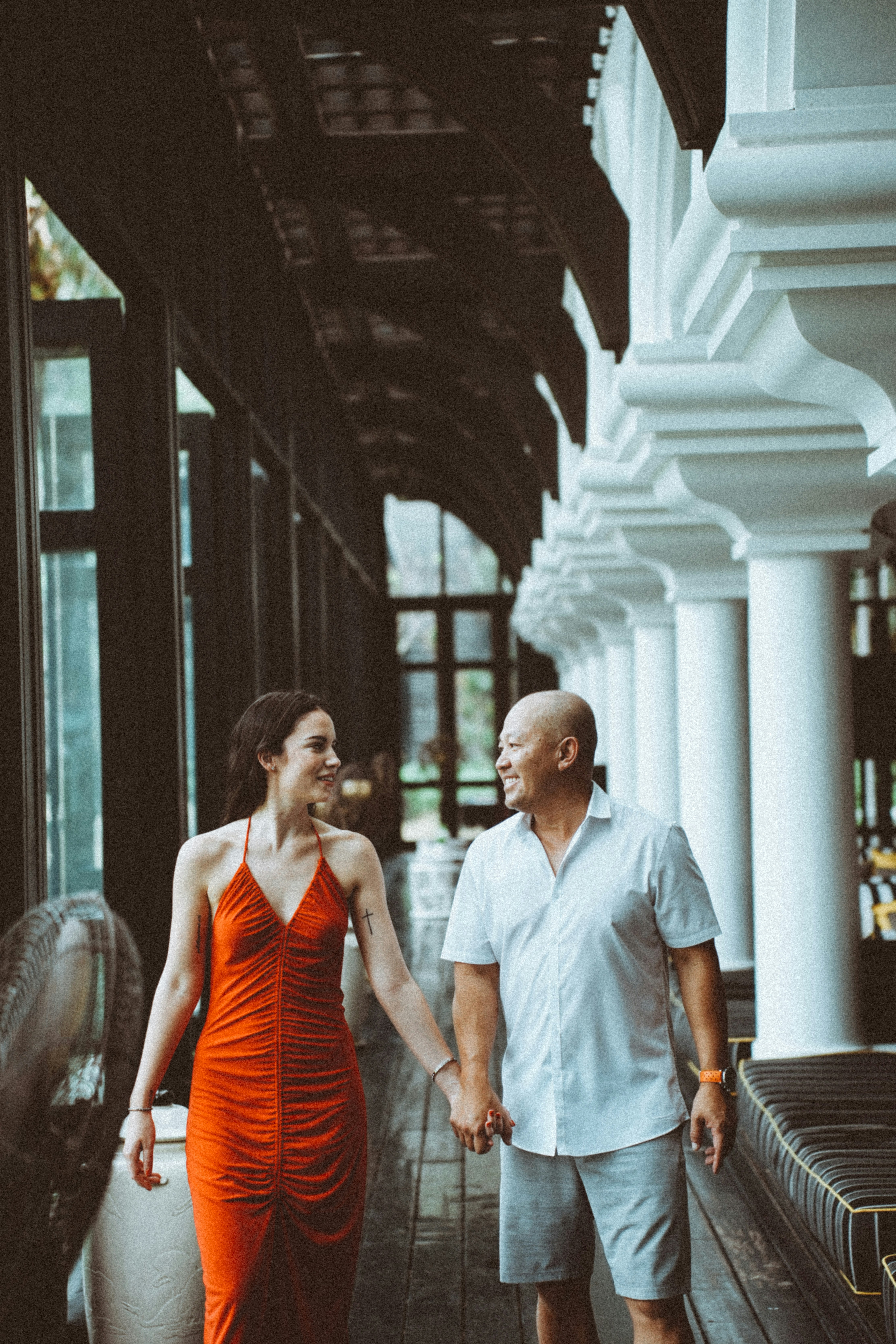 a man and woman walking down a hallway