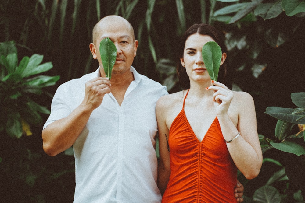 a man and woman holding a green object