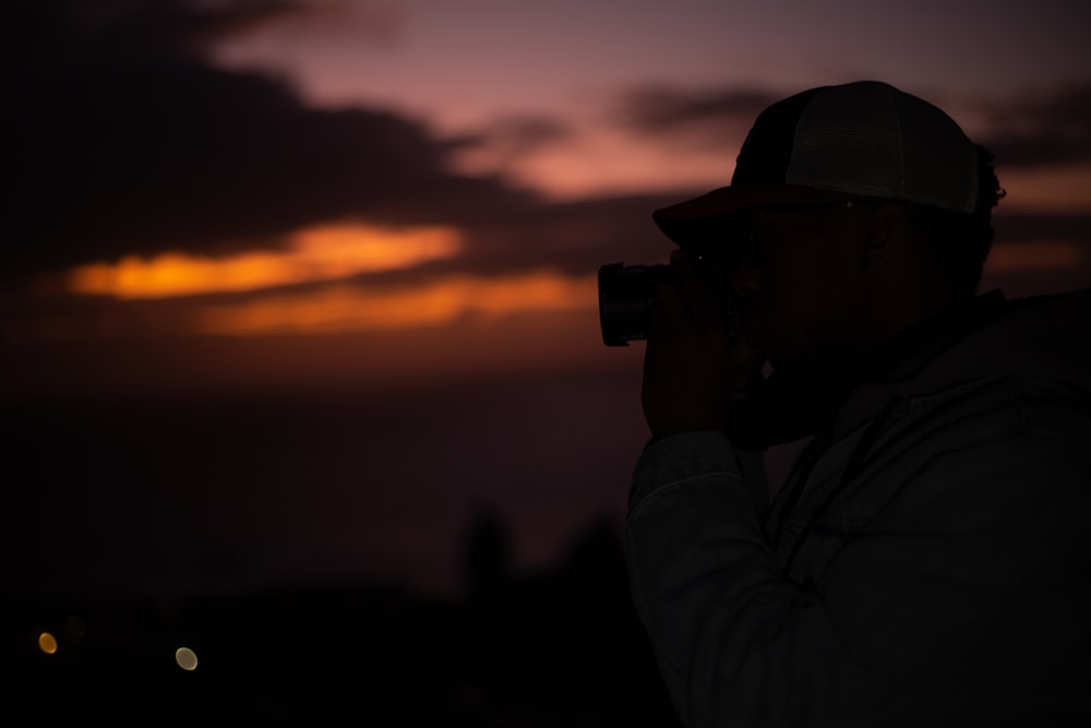 a person in a military uniform looking out at the sunset