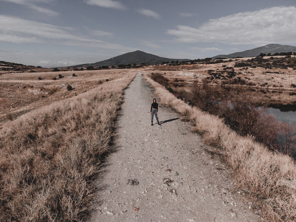 a person walking on a dirt road